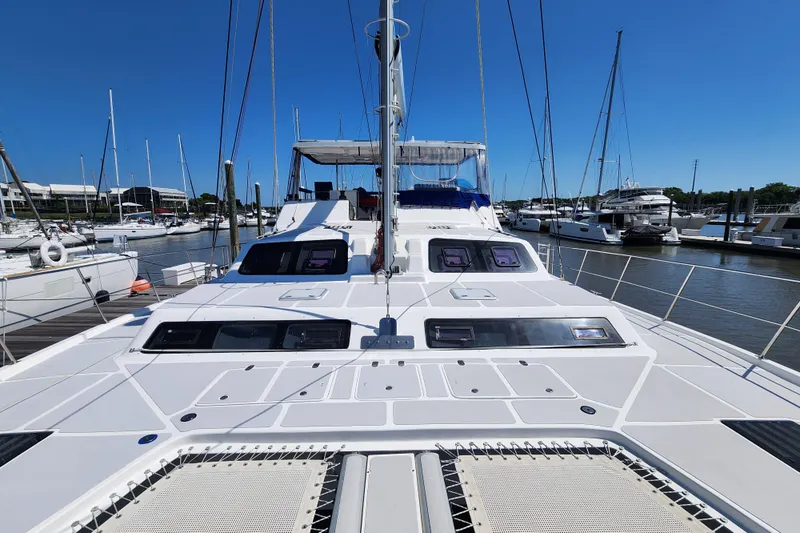 Slide: The Image of 2021 Royal Cape Catamarans Majestic 570 docked at a marina under clear blue skies. - 33