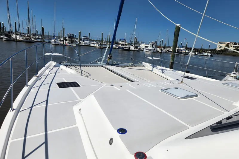 Slide: The Image of 2021 Royal Cape Catamarans Majestic 570 docked at marina, showcasing spacious deck. - 38