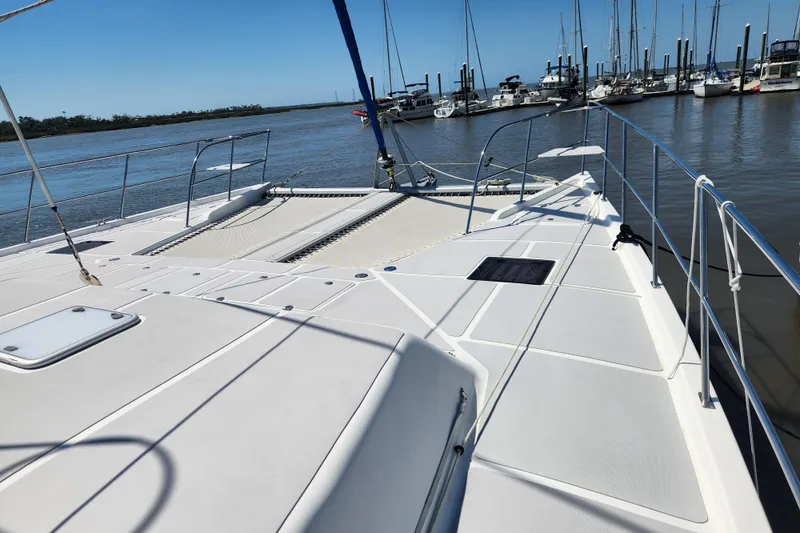 Slide: The Image of 2021 Royal Cape Catamarans Majestic 570 docked at marina, showcasing spacious deck. - 39