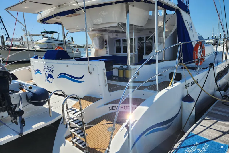 Slide: The Image of 2021 Royal Cape Catamarans Majestic 570 docked, showcasing elegant design and spacious deck. - 4