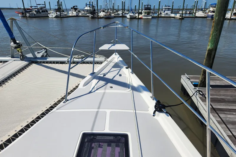 Slide: The Image of 2021 Royal Cape Catamarans Majestic 570 docked at marina, showcasing sleek deck design. - 40
