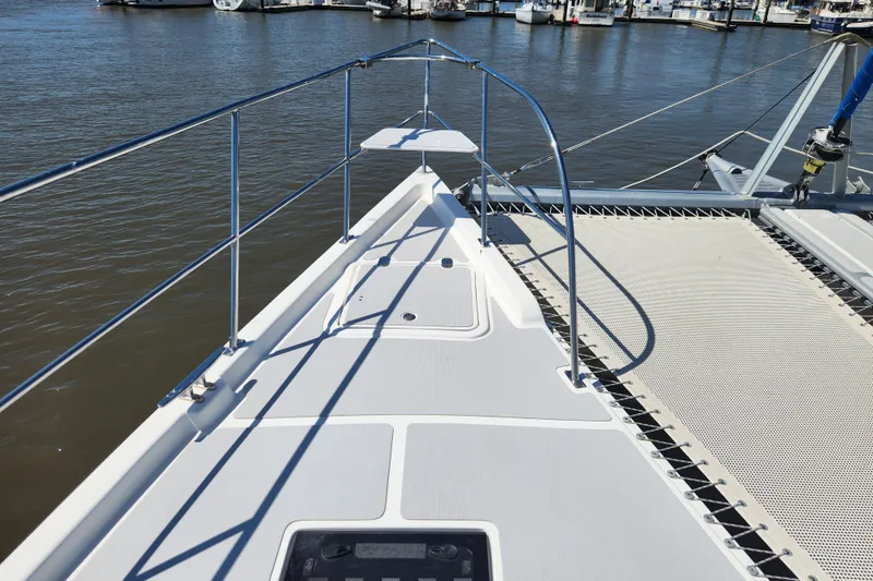 Slide: The Image of Deck view of 2021 Royal Cape Catamarans Majestic 570, docked at a marina. - 41
