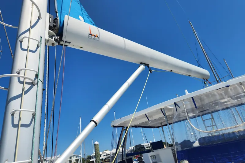 Slide: The Image of Royal Cape Catamarans Majestic 570 sailboat mast and boom, 2021 model, under clear blue sky. - 48