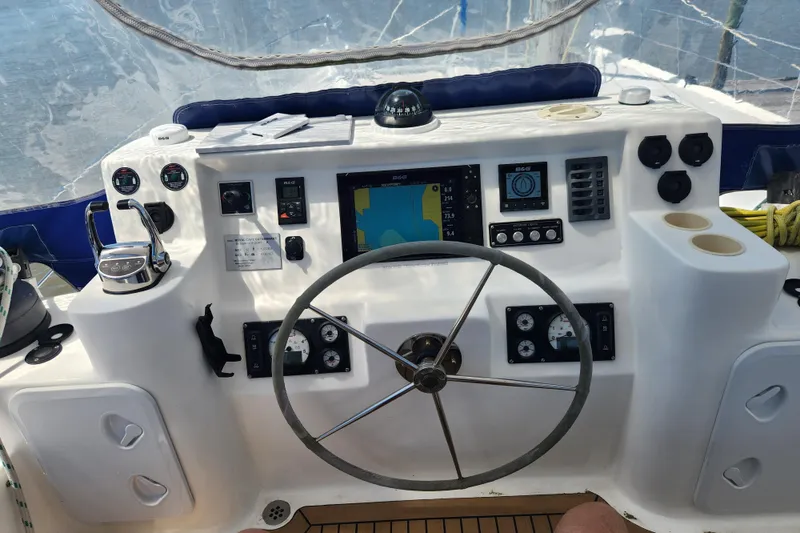 Slide: The Image of Cockpit of 2021 Royal Cape Catamarans Majestic 570 with navigation instruments and steering wheel. - 53