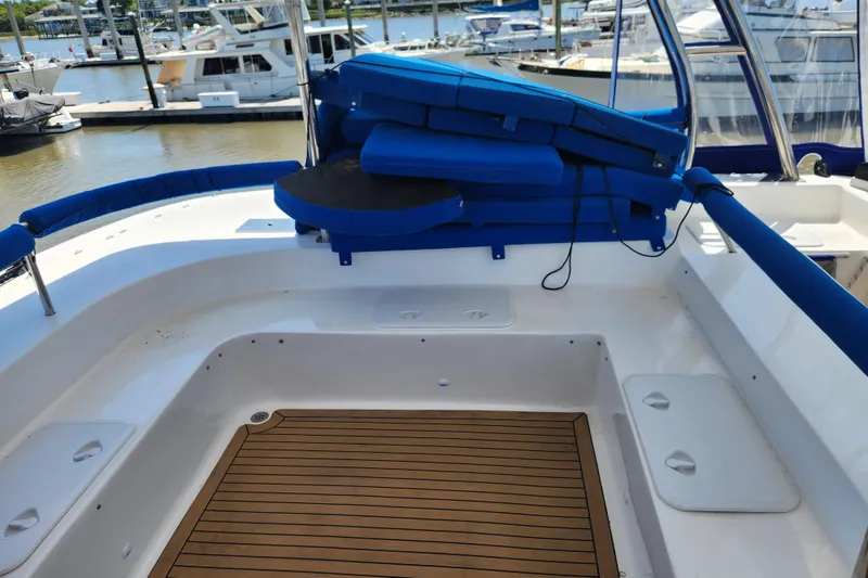 Slide: The Image of 2021 Royal Cape Catamarans Majestic 570 deck with blue cushions and wooden flooring. - 55