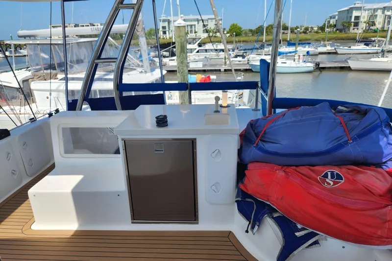 Slide: The Image of Royal Cape Catamarans Majestic 570 deck with storage and marina view, 2021 model. - 56