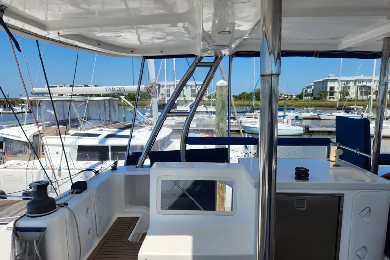 Slide: The Image of 2021 Royal Cape Catamarans Majestic 570 docked at a marina, showcasing its spacious deck. - 57