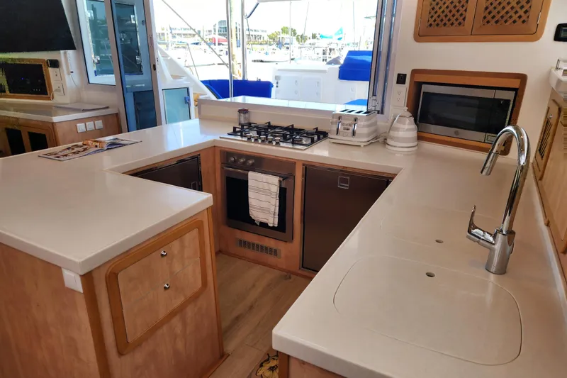 Slide: The Image of Modern kitchen interior of 2021 Royal Cape Catamarans Majestic 570 with appliances and sleek countertops. - 64
