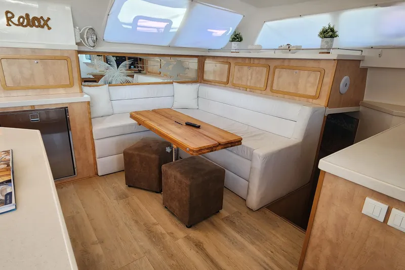 Slide: The Image of Luxurious interior of 2021 Royal Cape Catamarans Majestic 570 with cozy seating and elegant decor. - 65