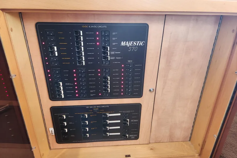 Slide: The Image of Electrical panel of 2021 Royal Cape Catamarans Majestic 570, showcasing circuit controls. - 70
