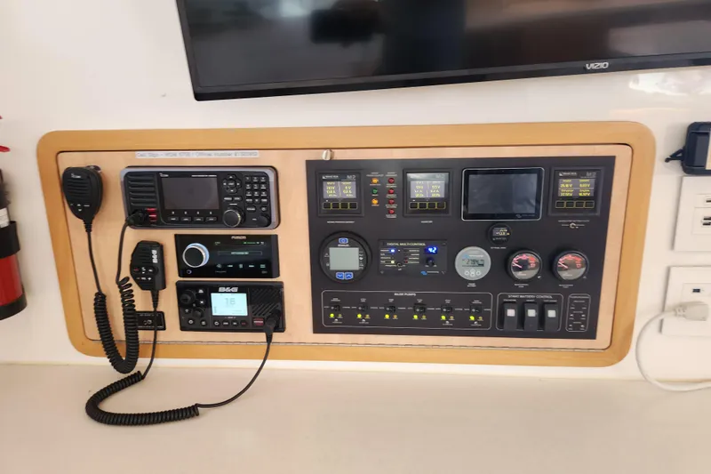 Slide: The Image of Control panel of a 2021 Royal Cape Catamarans Majestic 570, featuring navigation and communication equipment. - 71