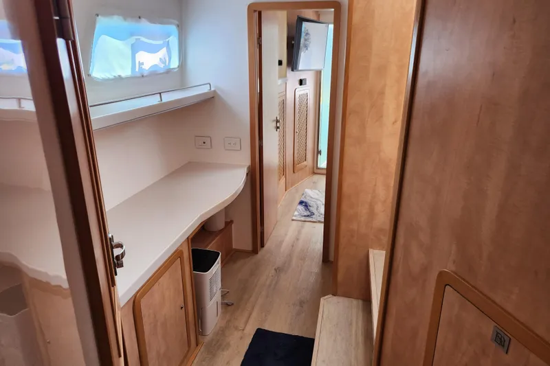 Slide: The Image of Interior of 2021 Royal Cape Catamarans Majestic 570, featuring wooden cabinetry and modern design. - 73