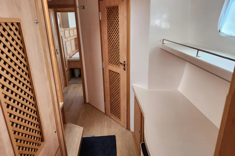 Slide: The Image of Interior of 2021 Royal Cape Catamarans Majestic 570, featuring wooden cabinetry and modern design. - 74