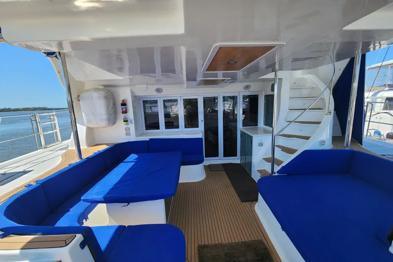 Slide: The Image of Luxurious 2021 Royal Cape Catamarans Majestic 570 interior with blue seating and elegant design. - 8