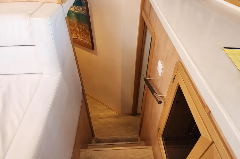 Slide: The Image of Interior of 2021 Royal Cape Catamarans Majestic 570, featuring stairs and modern wood finish. - 83