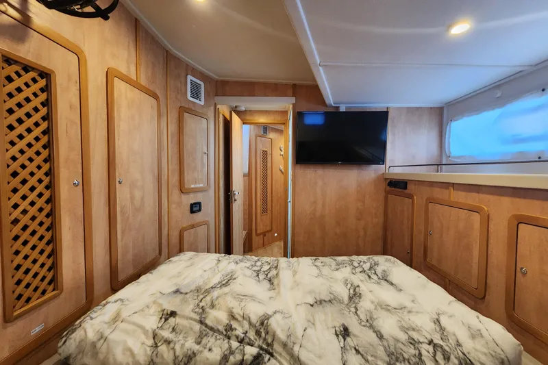 Slide: The Image of Luxurious cabin interior of 2021 Royal Cape Catamarans Majestic 570 with wood paneling and TV. - 87