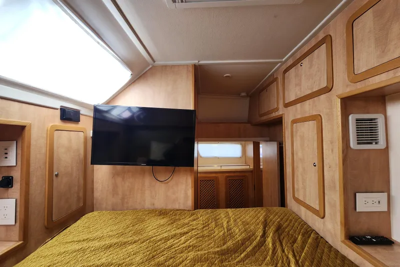 Slide: The Image of Luxurious cabin interior of 2021 Royal Cape Catamarans Majestic 570 with TV and wood finish. - 90