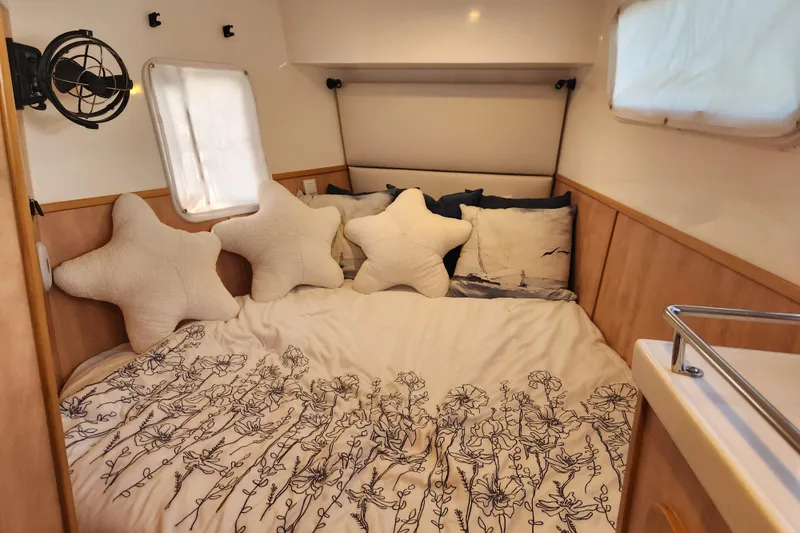 Slide: The Image of Cozy cabin interior of 2021 Royal Cape Catamarans Majestic 570 with star-shaped pillows. - 91