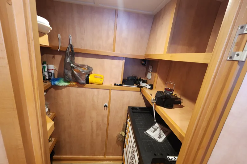 Slide: The Image of Storage area inside a 2021 Royal Cape Catamarans Majestic 570, featuring shelves and various items. - 94