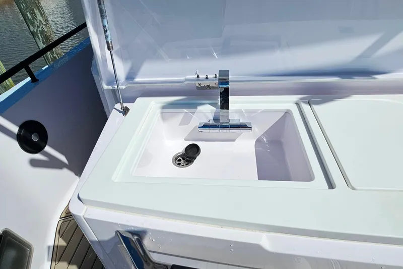 Slide: The Image of Outdoor sink on 2023 Axopar 37 XC Cross Cabin boat, featuring modern faucet design. - 14