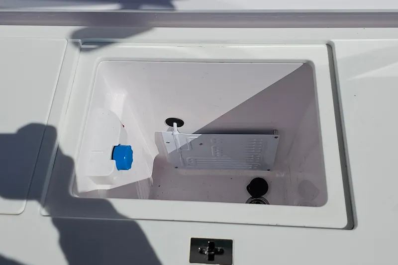 Slide: The Image of Storage compartment of 2023 Axopar 37 XC Cross Cabin boat, featuring a white interior. - 15