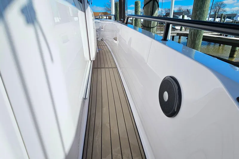 Slide: The Image of 2023 Axopar 37 XC Cross Cabin boat deck with sleek design and wood flooring. - 20