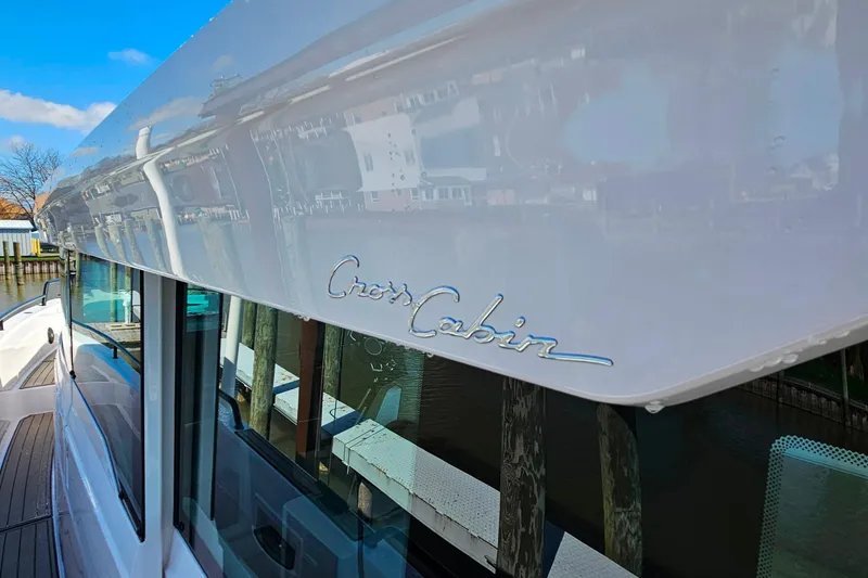 Slide: The Image of 2023 Axopar 37 XC Cross Cabin boat with sleek design and reflective windows. - 22