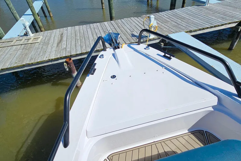 Slide: The Image of Bow view of 2023 Axopar 37 XC Cross Cabin docked at a marina. - 24