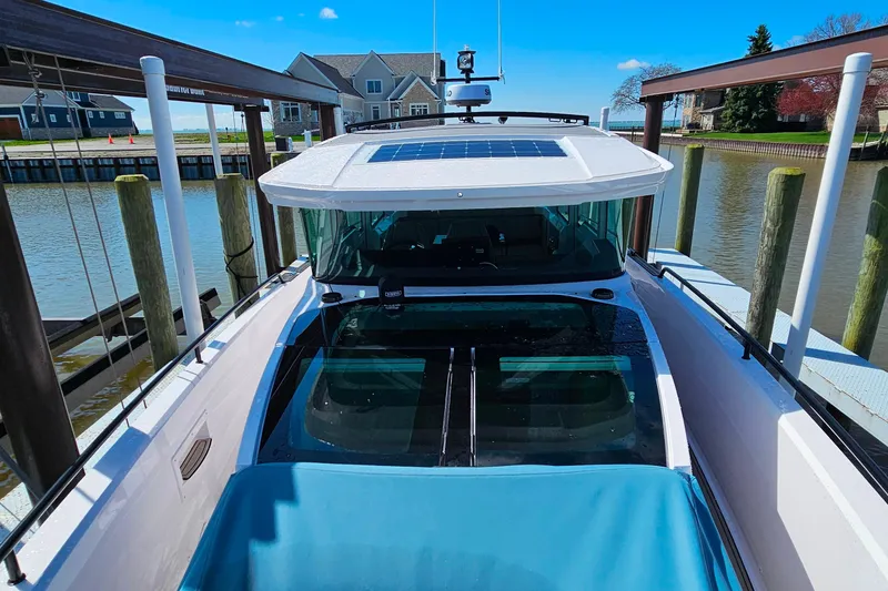 Slide: The Image of 2023 Axopar 37 XC Cross Cabin docked by waterfront homes. - 25