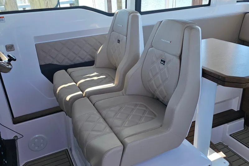 Slide: The Image of Luxurious seating inside 2023 Axopar 37 XC Cross Cabin with diamond-stitched upholstery. - 32