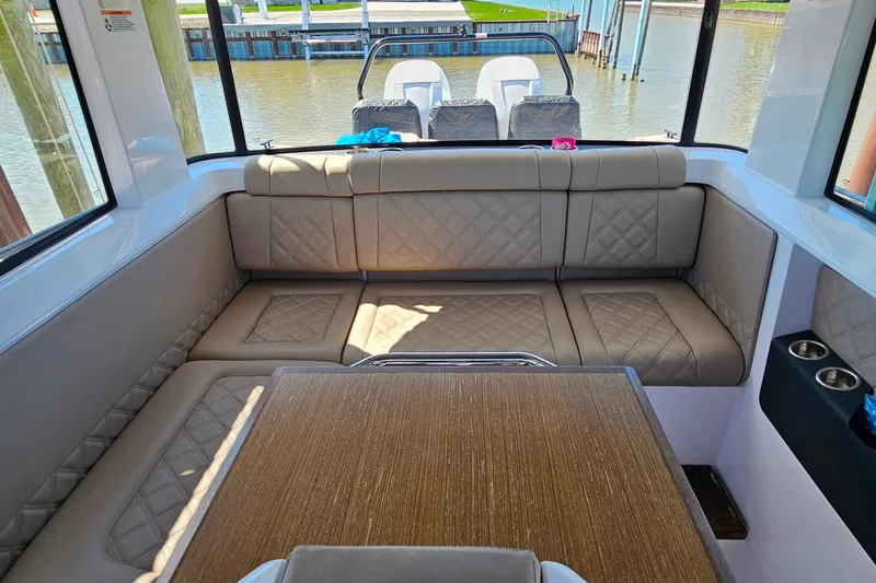Slide: The Image of Luxurious interior of 2023 Axopar 37 XC Cross Cabin with plush seating and elegant table. - 34