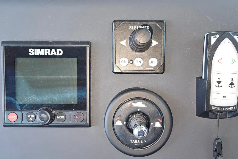 Slide: The Image of Control panel of 2023 Axopar 37 XC Cross Cabin with Simrad display and Side-Power controls. - 38