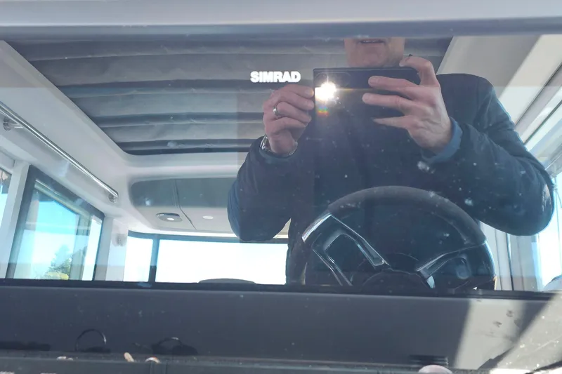 Slide: The Image of Reflection on Axopar 37 XC Cross Cabin dashboard, featuring Simrad electronics, 2023 model. - 39