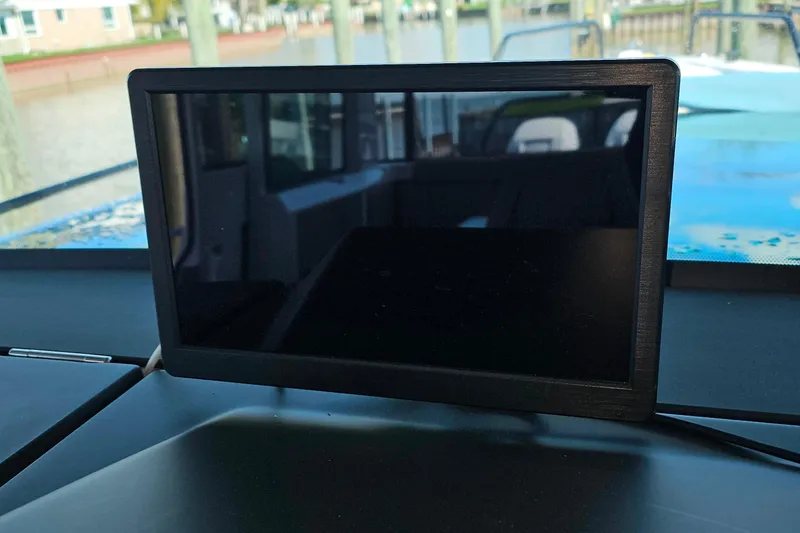 Slide: The Image of Dashboard screen inside 2023 Axopar 37 XC Cross Cabin boat, with marina view. - 40