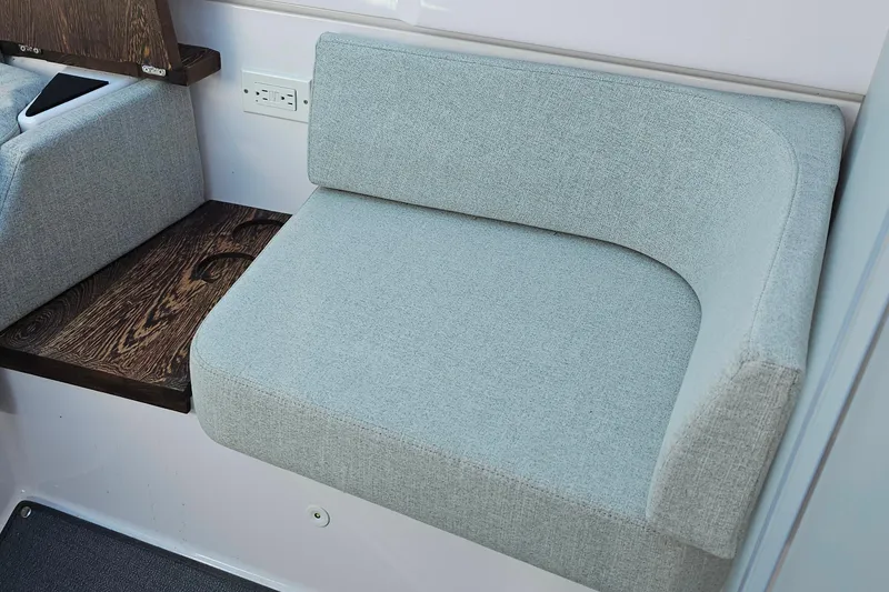Slide: The Image of Gray cushioned seating in 2023 Axopar 37 XC Cross Cabin boat interior. - 44