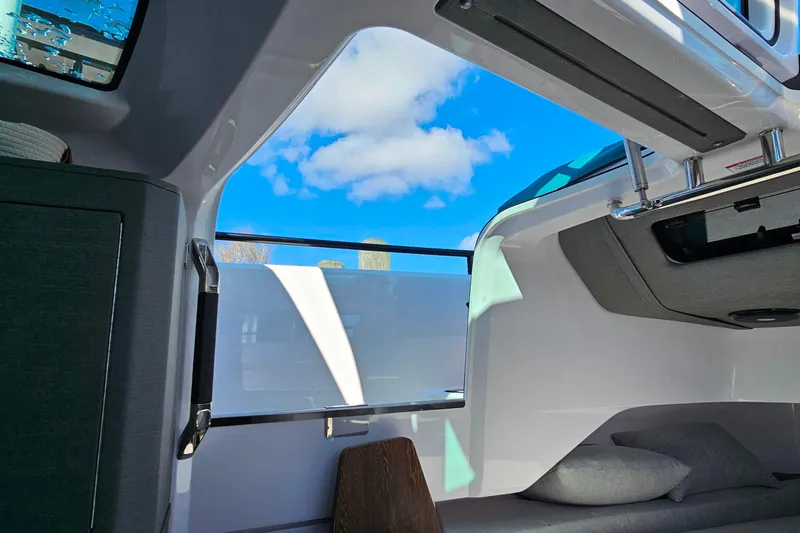 Slide: The Image of Interior view of 2023 Axopar 37 XC Cross Cabin with blue sky through window. - 48