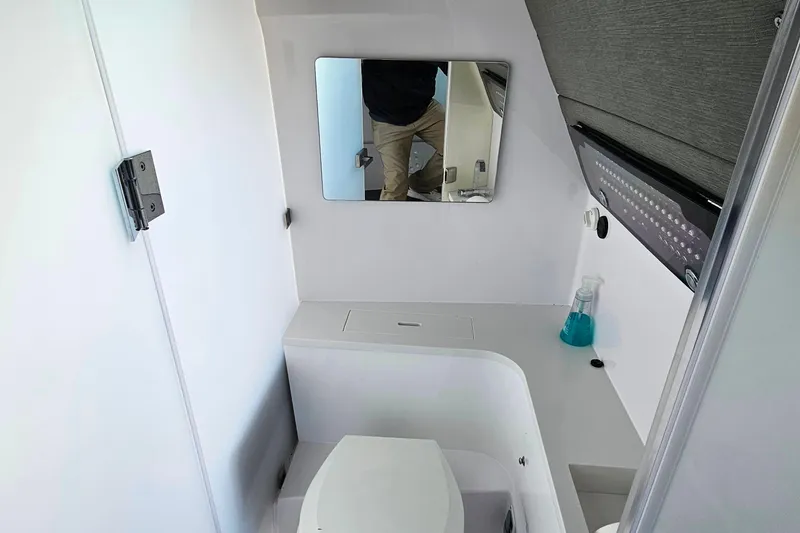 Slide: The Image of 2023 Axopar 37 XC Cross Cabin bathroom with mirror and modern fixtures. - 50