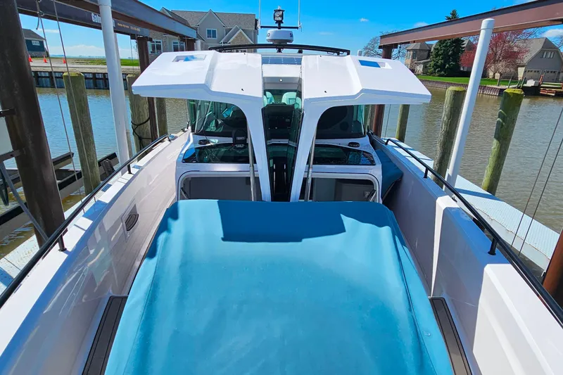 Slide: The Image of 2023 Axopar 37 XC Cross Cabin docked by waterfront homes. - 52