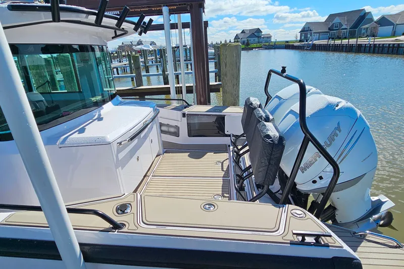 Slide: The Image of 2023 Axopar 37 XC Cross Cabin with Mercury engine docked by waterfront homes. - 6