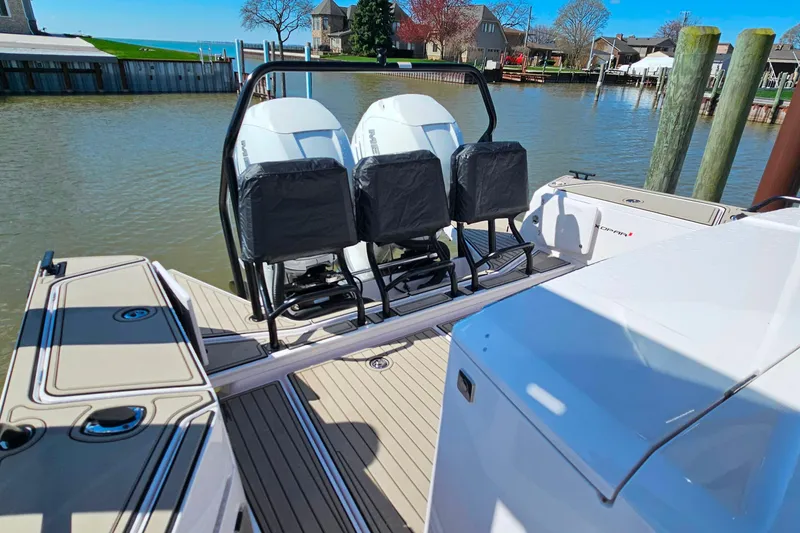 Slide: The Image of 2023 Axopar 37 XC Cross Cabin with dual outboard engines docked by the water. - 8