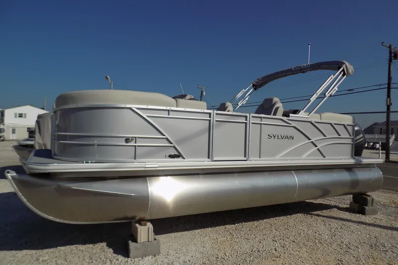 The Image of 2023 Sylvan Mirage 8522 LZ pontoon boat displayed outdoors on gravel. - 0