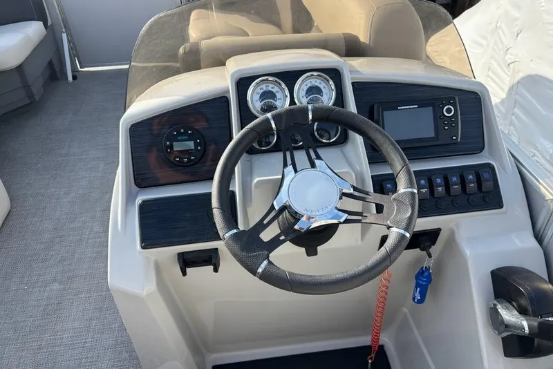 Slide: The Image of 2023 Sylvan Mirage 8522 LZ boat dashboard with steering wheel and control panel. - 15