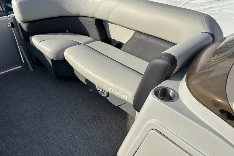 Slide: The Image of 2023 Sylvan Mirage 8522 LZ boat interior with gray seating and cup holder. - 18