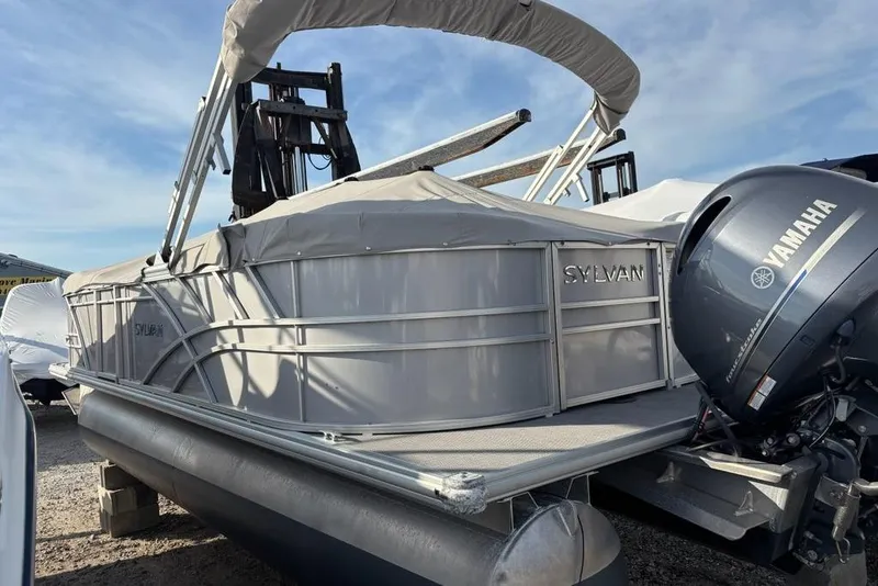 Slide: The Image of 2023 Sylvan Mirage 8522 LZ pontoon boat with Yamaha outboard motor, docked outdoors. - 4