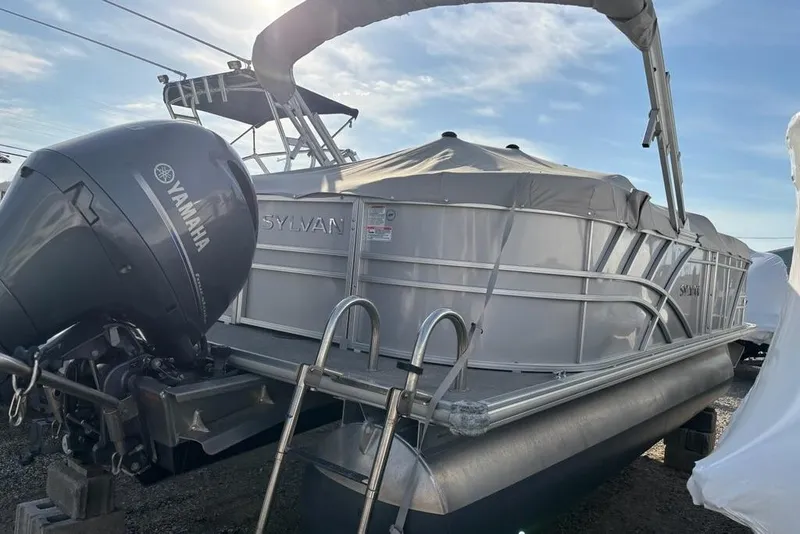 Slide: The Image of 2023 Sylvan Mirage 8522 LZ pontoon boat with Yamaha outboard motor, covered and docked. - 5