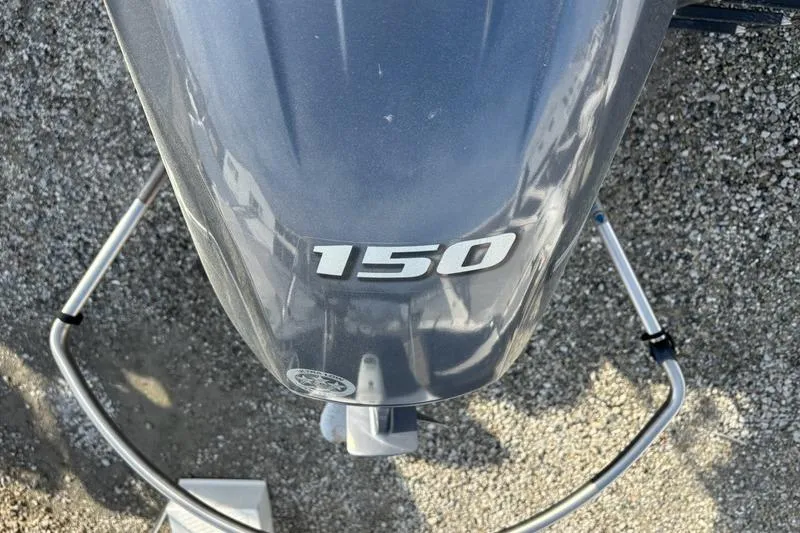 Slide: The Image of Top view of a 2023 Sylvan Mirage 8522 LZ boat engine with "150" label. - 6