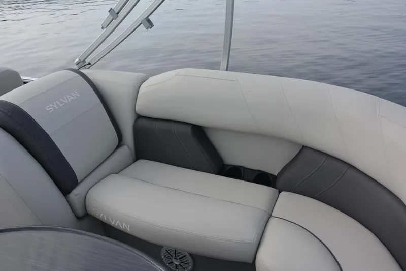 Slide: The Image of Manufacturer Provided Image: 2023 Sylvan Mirage 8522 LZ boat interior seating with gray and white upholstery. - 8