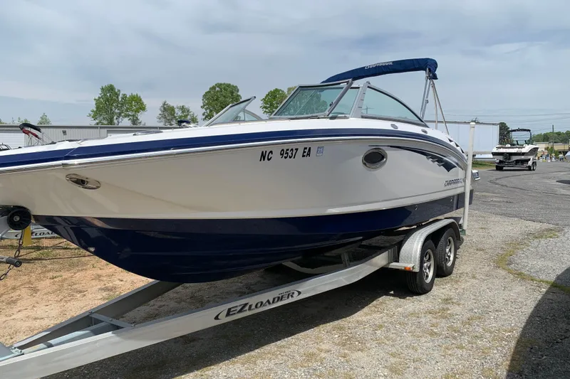 Slide: The Image of 2014 Chaparral 244 Sunesta boat on trailer, parked outdoors. - 2