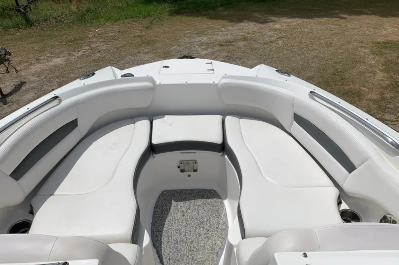 Slide: The Image of 2014 Chaparral 244 Sunesta boat interior with white seating and carpeted floor. - 4