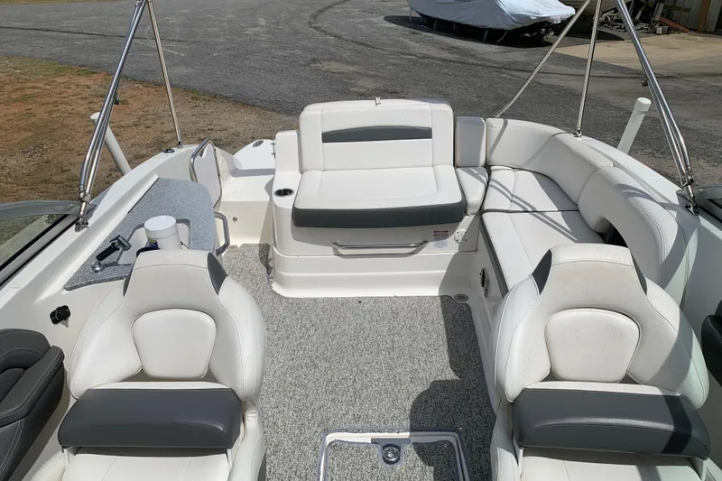 Slide: The Image of 2014 Chaparral 244 Sunesta boat interior with white seating and gray accents. - 5